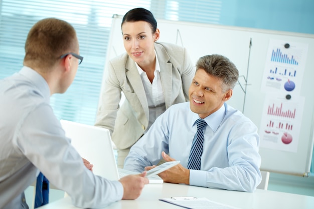 Ambitious executive listening to his workmate