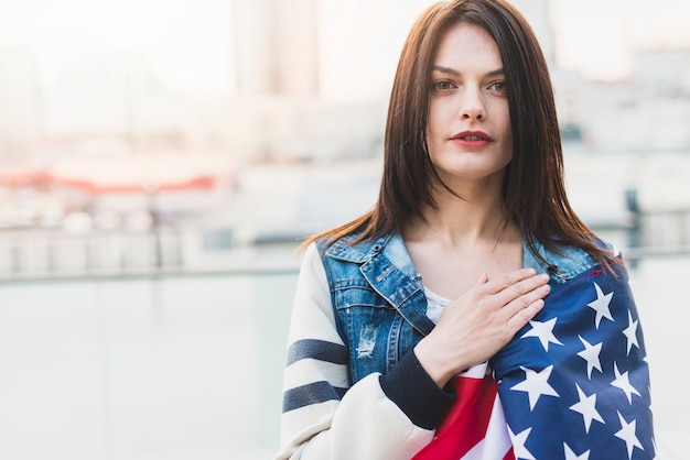 American female patriot holding hand on heart