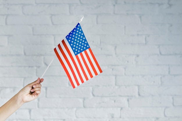 American flag background with hand holding flag