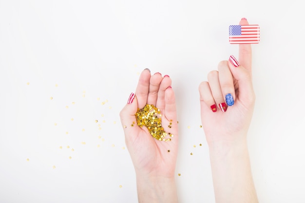 Free photo american flag on finger and confetti in hand