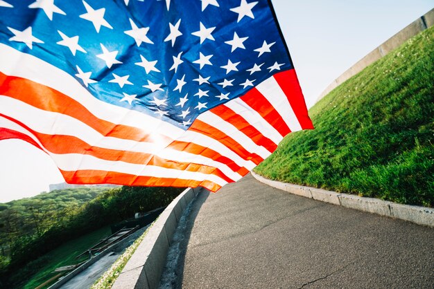 American flag with road and sunshine