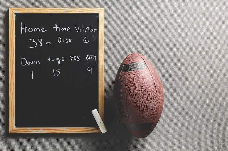 Free Photo american football ball lying near match score