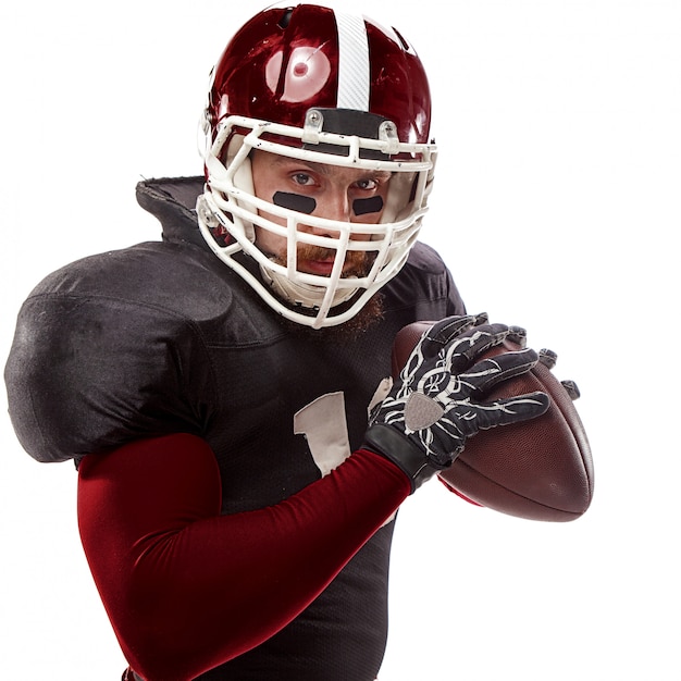 American football player posing with ball on white