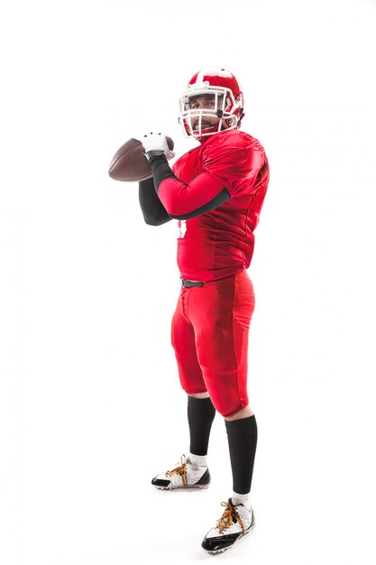 Free photo american football player posing with ball on white