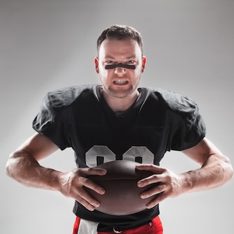 American football player posing with ball