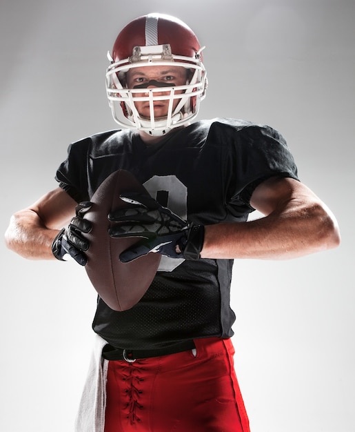 American football player posing with ball