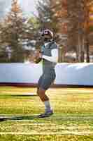 Free photo american football player in uniform training on the field