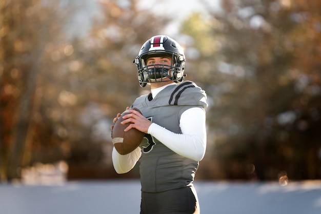 Free photo american football player in uniform training on the field