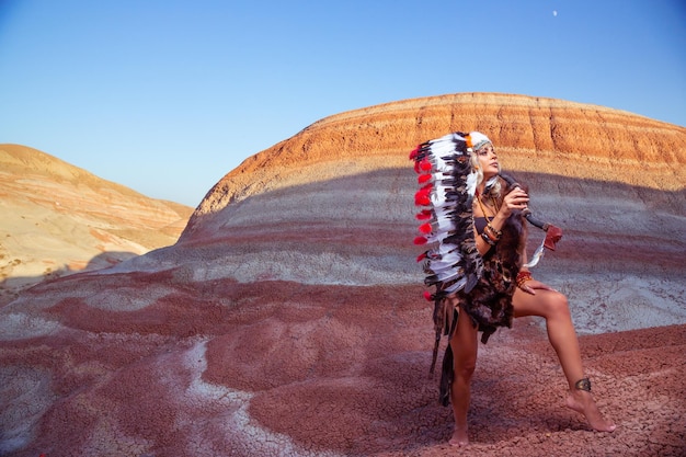 American Indian girl in native costume headdress made of feathers of birds