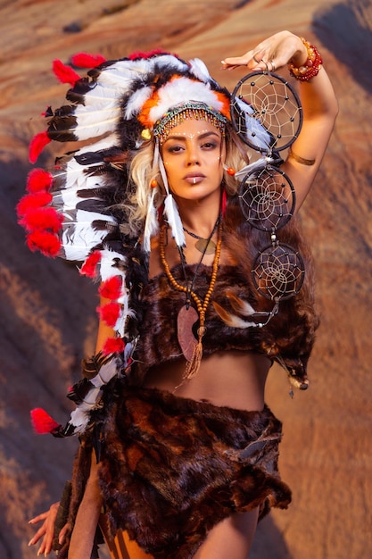 American Indian girl in native costume headdress made of feathers of birds