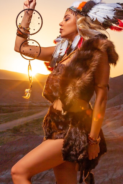 American Indian girl in native costume headdress made of feathers of birds