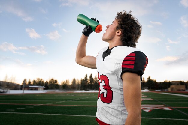 American male football player in uniform on the field