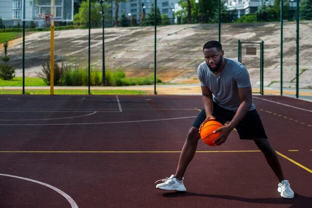 American man holding ball long shot