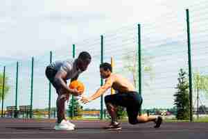 Free photo american men playing urban basketball long shot