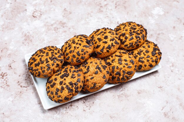 American style chocolate chip cookies on light concrete background.