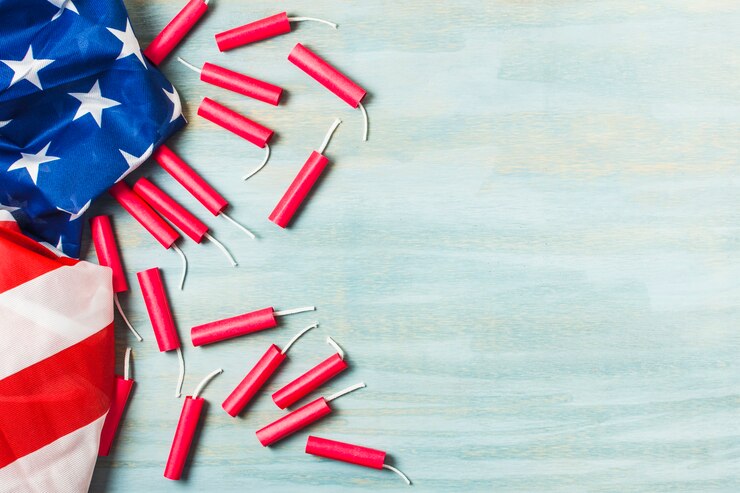 Free Photo an american usa flag with red firecrackers on textured background