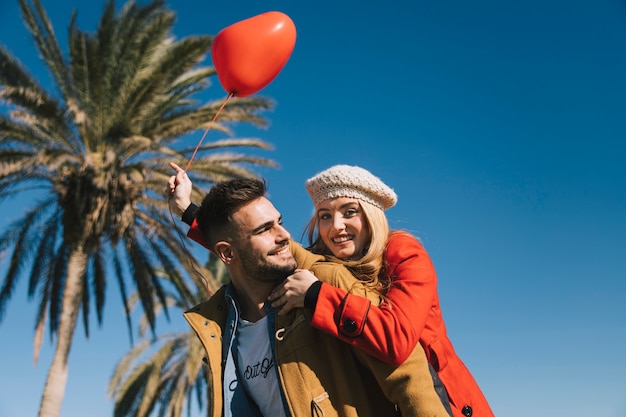 Free photo amorous young couple with balloon on shore