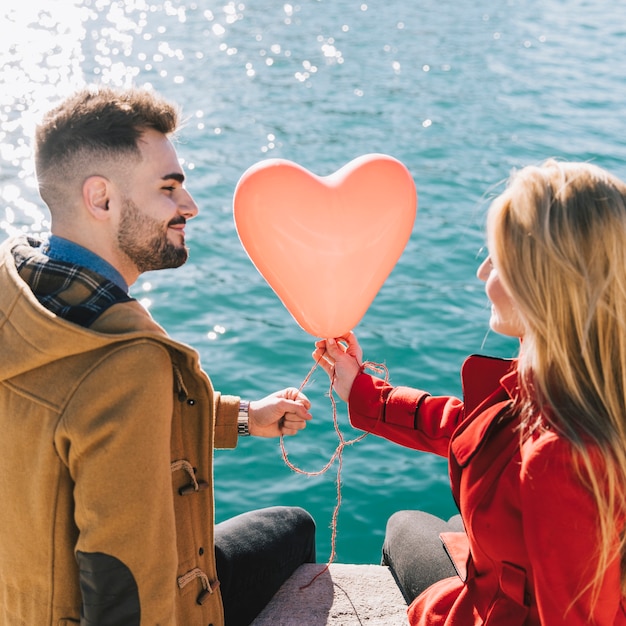 Amorous young couple with balloon