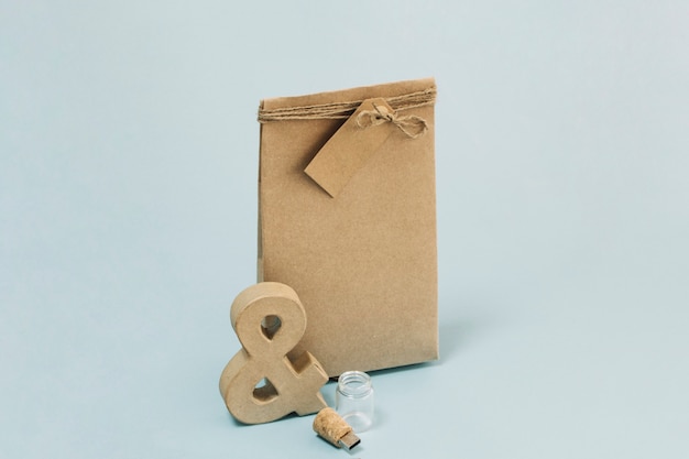 Ampersand and flash drive near paper bag