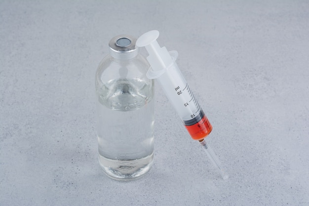 Ampoule and syringe for injection on marble background. 