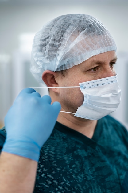 Anaesthetist putting his mask on