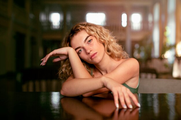 Analog portrait of beautiful woman posing artistically indoors