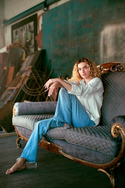 Free photo analog portrait of beautiful woman posing indoors on a couch