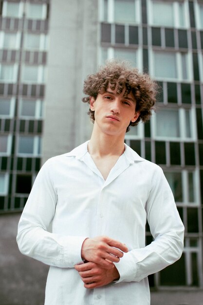 Analog portrait of handsome man posing artistically outdoors