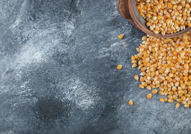 An ancient bowl full of uncooked popcorn seeds.