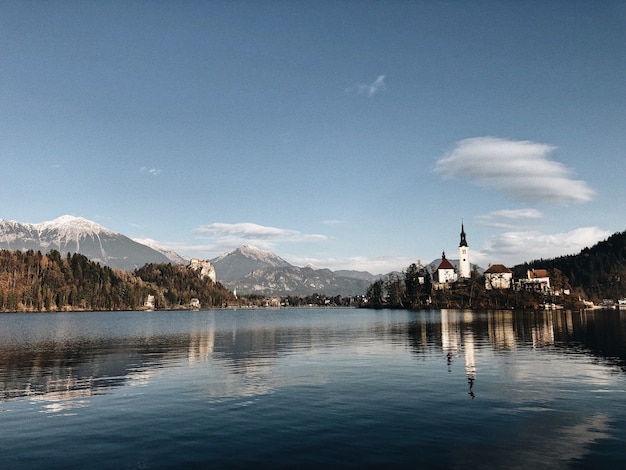 Foto gratuita antico castello circondato da uno scenario montuoso che si riflette nel lago