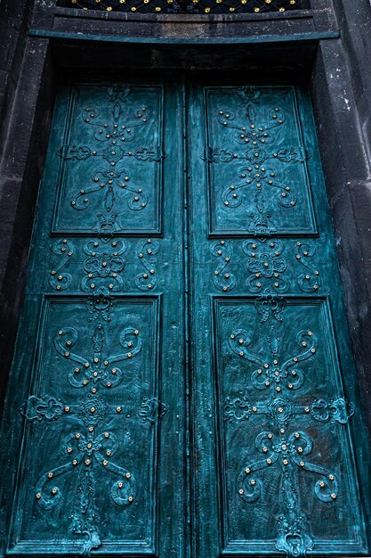 Ancient doors in the cathedral turquoise old doors