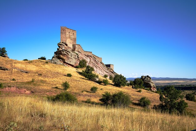 Ancient fortress in a field captured on a sunny day