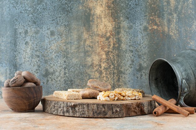 Ancient kettle and peanut brittles on marble background