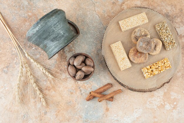 Ancient kettle and peanut brittles on marble background