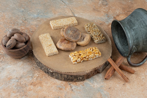 Ancient kettle and peanut brittles on marble background