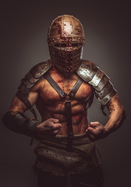 Angry bloody gladiator in helmet and ancient armor.