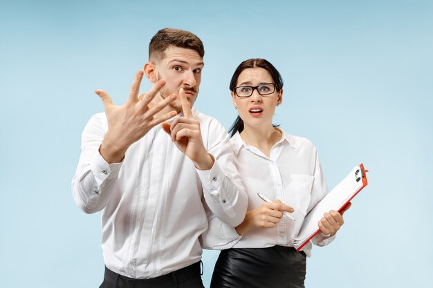 Angry boss. Man and his secretary standing at office. Business man screaming to his colleague. Female and male caucasian models. Office relationships concept, Human emotions