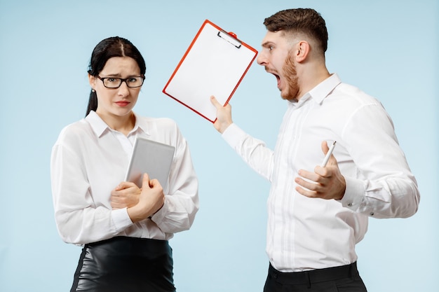 Free photo angry boss. man and his secretary standing at office or studio. business man screaming to his colleague. office relationships concept, human emotions