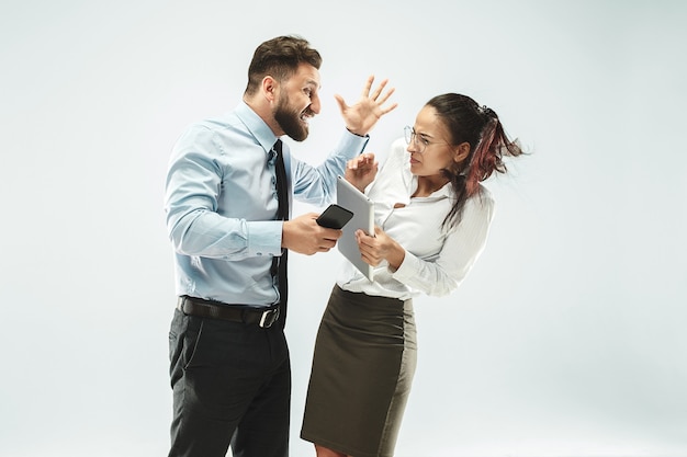 Angry boss. man and his secretary standing at office or studio.