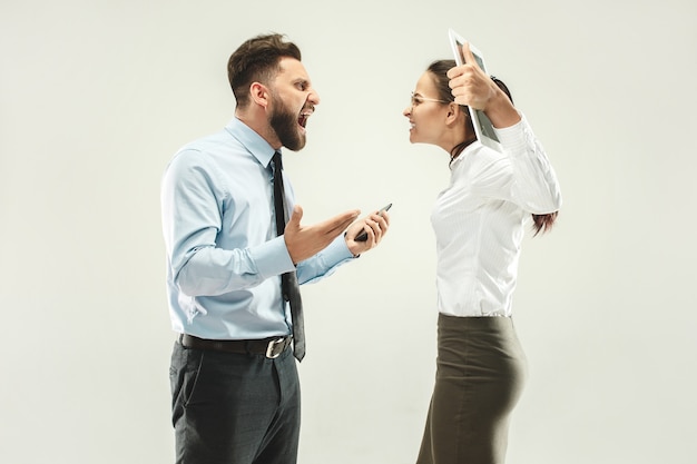 Free photo angry boss. man and his secretary standing at office or studio