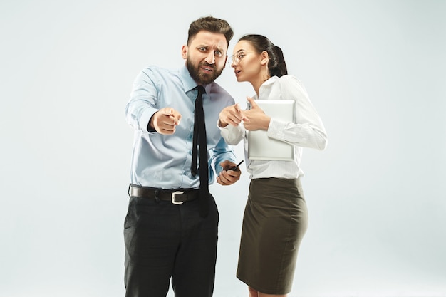 Free photo angry boss. man and his secretary standing at office or studio