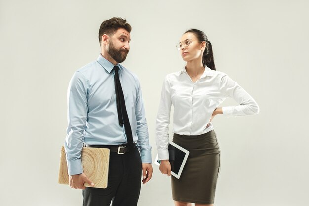 Angry boss. Man and his secretary standing at office