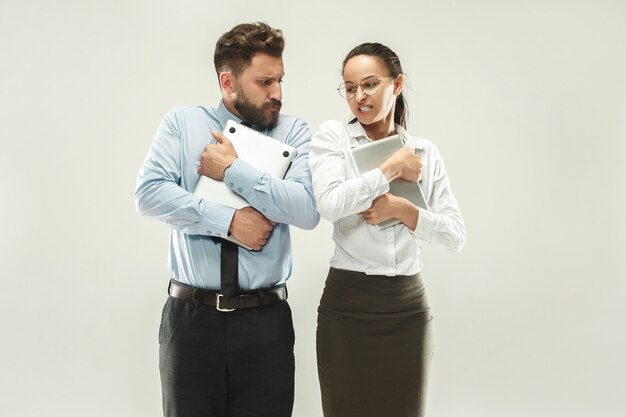 Angry boss. Man and his secretary standing at office 