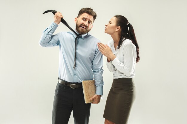 Angry boss. Man and his secretary standing at office 