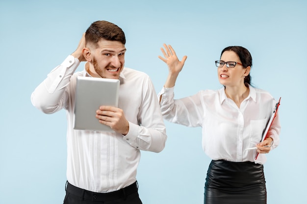 Angry boss. Woman and his secretary standing at office or studio. Businesswoman screaming to his colleague. Female and male caucasian models. Office relationships concept, Human emotions