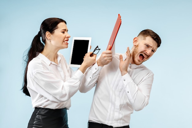 Angry boss. Woman and his secretary standing at office or studio. Businesswoman screaming to his colleague. Female and male caucasian models.