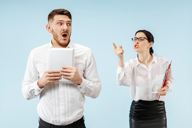 Angry boss. Woman and his secretary standing at office or studio. Businesswoman screaming to his colleague.