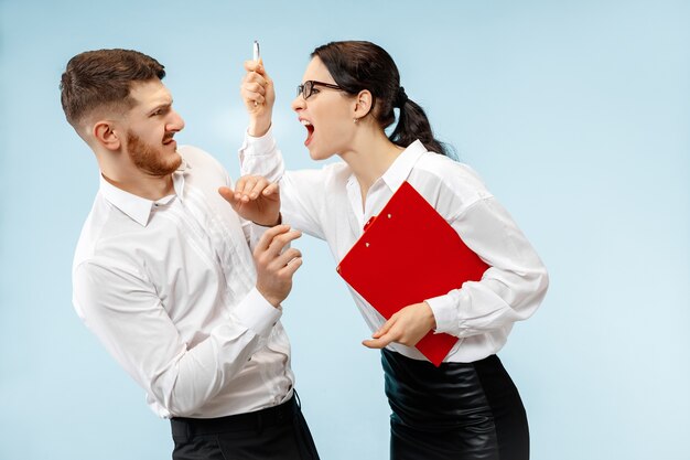 Angry boss. Woman and his secretary standing at office or studio.