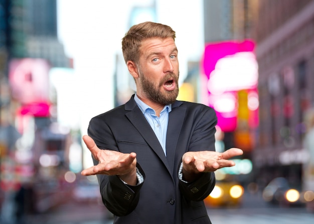 Free photo angry businessman with open hands