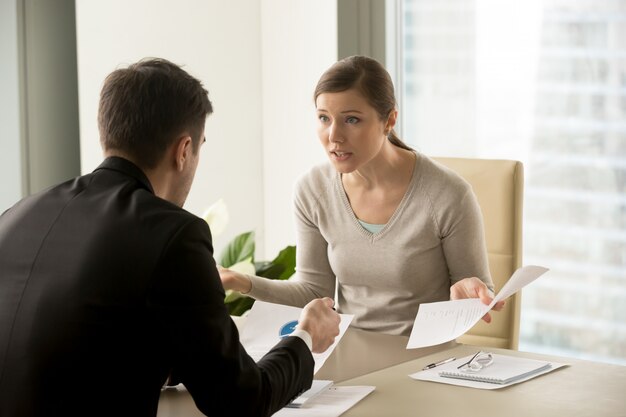 angry businesswoman arguing with businessman